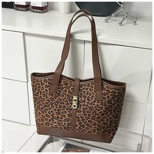 Detailansicht der Leopard-Print-Einkaufstasche mit braunen Henkeln und goldener Schnalle