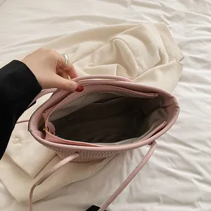 Pink pleated tote bag with internal storage compartment and soft fabric lining