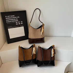 Vintage suede patchwork tote bags in caramel and khaki colors with beaded tassels