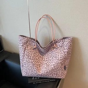Pink leopard print tote bag with minimalist rope handles for casual daily commuting