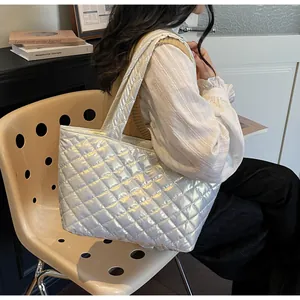 Close-up of a silver quilted tote bag with metallic glossy finish and diamond patterns