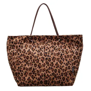 Large leopard print tote bag with brown handles and knotted metal hardware details