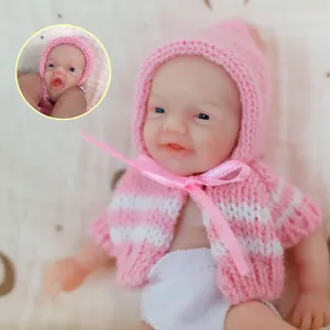 6-inch soft silicone mini reborn baby doll in pink knitted outfit with blue eyes
