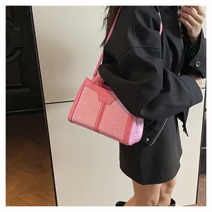 Pink faux crocodile leather shoulder bag on female model in black jacket outfits