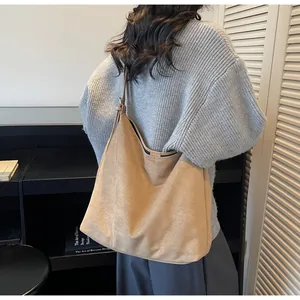 Detail view of the khaki faux suede shoulder bag showing soft texture and large capacity