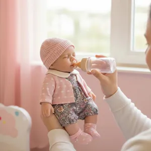 Realistic 12 inch solid silicone reborn doll with pink knit outfit and feeding bottle
