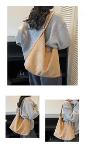 Detailed view of the large capacity khaki suede shoulder bag with adjustable strap