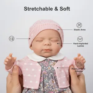 Realistic 12 inch solid silicone reborn baby doll with pink knit hat and floral dress