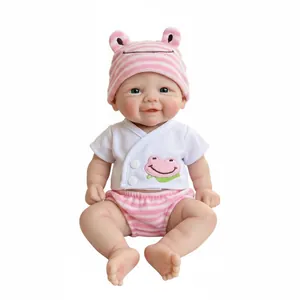 Realistic 12 inch solid silicone reborn baby doll wearing a pink frog themed outfit