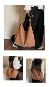 Close-up of brown suede hobo bag showing adjustable thin shoulder strap and soft texture