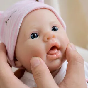 Lifelike 12-inch silicone baby doll wearing a pink striped hat with realistic skin texture