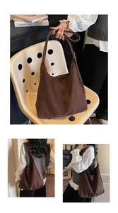 Detail of a brown suede hobo bag with adjustable strap and textured matte finish