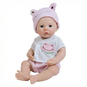 Realistic 12 inch solid silicone reborn baby doll wearing a pink frog hat and stripe suit