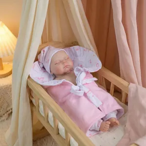 12 inch lifelike reborn baby doll in pink sleeping bag with wooden cradle display