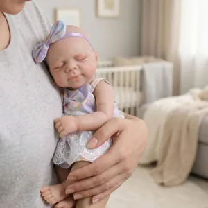 Lifelike 12-inch reborn baby doll in purple floral dress and bow headband for kids