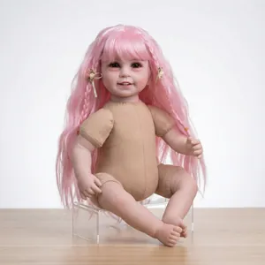 Realistic reborn doll with pink long hair and floral accessories in a seated pose