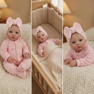 18-inch realistic reborn baby doll in pink polka dot outfit with a large bow headband