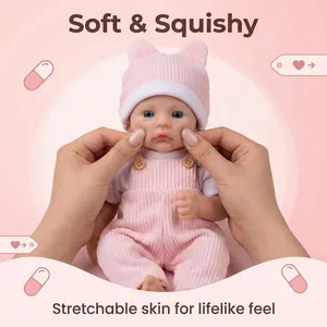 12-inch realistic soft silicone baby doll wearing pink striped outfit and overalls