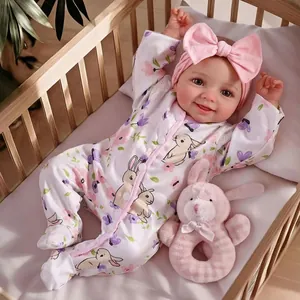 Realistic 17-inch reborn baby doll in floral romper with rabbit plush toy and headband