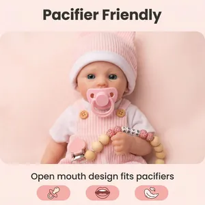 12 inch realistic silicone baby doll wearing pink knit hat and outfit with pacifier