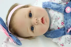 Close-up of reborn baby doll featuring realistic blue eyes and delicate long eyelashes