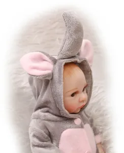 Detail of baby doll in gray elephant plush outfit on a soft white carpet background