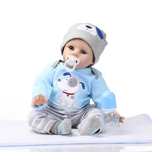 Realistic reborn baby doll in blue puppy outfit with bottle and pacifier accessories