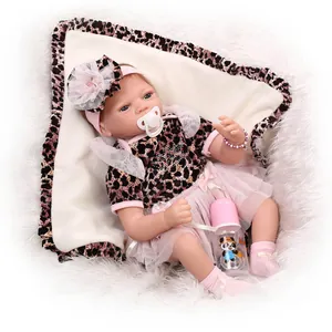 Lifelike reborn baby doll in pink leopard outfit with feeding bottle and pacifier accessories