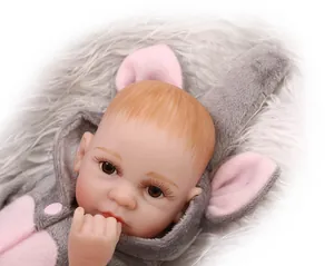 Close-up of a realistic reborn baby doll with long lashes wearing a grey plush hoodie