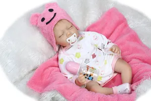 Detailed view of lifelike sleeping baby doll with plush bear hat and nursery accessories