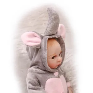 Realistic reborn baby doll in a plush grey and pink elephant onesie on soft white fur