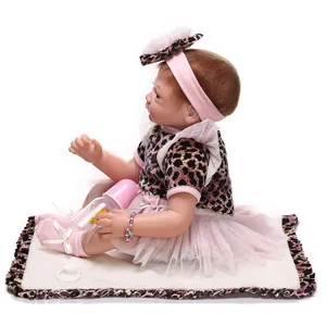 Realistic reborn baby doll in leopard print top and pink tutu skirt with accessories