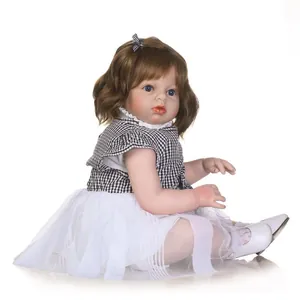 Realistic reborn toddler girl doll with curly hair in a black and white plaid dress outfit