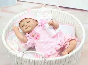 Detailed close-up of a lifelike reborn baby doll in a cozy pink woven basket