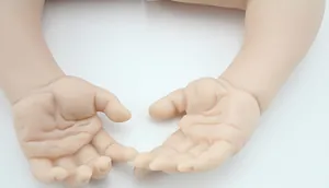 Macro shot of realistic silicone reborn doll replacement hands with detailed skin texture