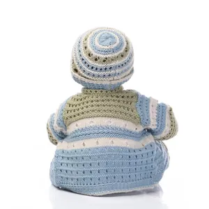 Macro shot of back view showing handcrafted hollow knit patterns on striped baby doll outfit