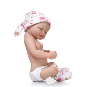 Detailed view of realistic soft silicone baby doll with sleeping face and cute animal prints