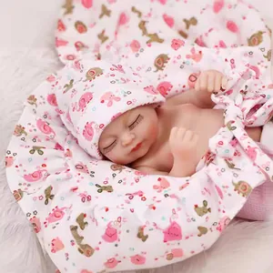 Realistic sleeping baby doll with floral hat and pink ruffle swaddle on faux fur