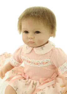 Close-up of lifelike doll facial details with delicate hand-painted blush and pink knit lace outfit