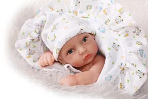 Close-up of lifelike baby doll with detailed skin texture, blue eyes and cotton animal hat
