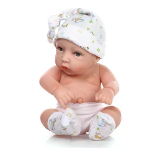 Detailed view of a soft silicone newborn baby doll with a cartoon hat and white diaper