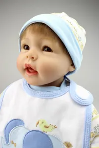 Lifelike reborn baby doll in soft light blue cotton outfit with cute animal embroidery