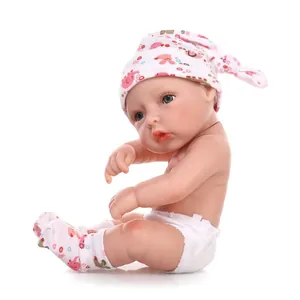 Detailed close-up of a lifelike reborn baby doll wearing a pink elephant hat and diaper