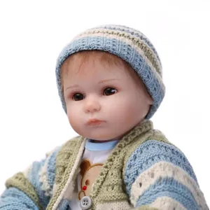 Realistic reborn baby doll in blue striped knit sweater and brown bear print tee