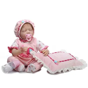 Realistic sleeping baby reborn doll in pink lace outfit with bottle and pacifier accessories