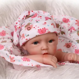 Close-up of soft reborn baby doll with realistic skin texture and printed headwear