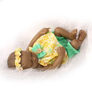 Detailed close-up of a realistic black reborn doll in a yellow floral outfit