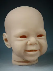 Close-up of unpainted soft silicone reborn doll head mold with realistic smiling expression