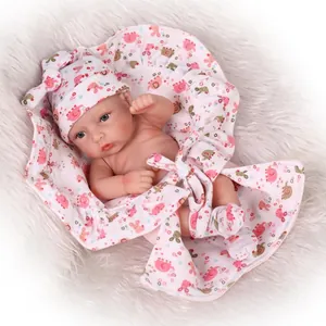 Realistic reborn baby doll with blue eyes in pink elephant outfit and matching accessories