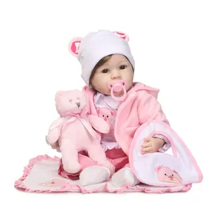 Lifelike reborn baby doll in pink hooded outfit with plush bear and accessories set
